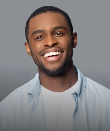 A smiling young man with a full, even smile